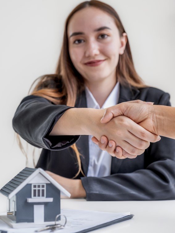 Real estate agents how to get funding for your real estate deal sale broker and buyers handshake after signing a business contract at home office